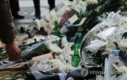 White mourning flowers and condolence drinks offered by citizens lie near Itaewon Station in Seoul on Nov. 1, 2022. (Yonhap)