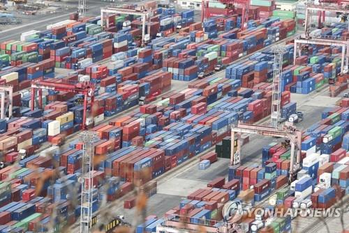 This undated file photo shows containers for exports and imports stacked at a pier in South Korea's largest port city of Busan. (Yonhap)