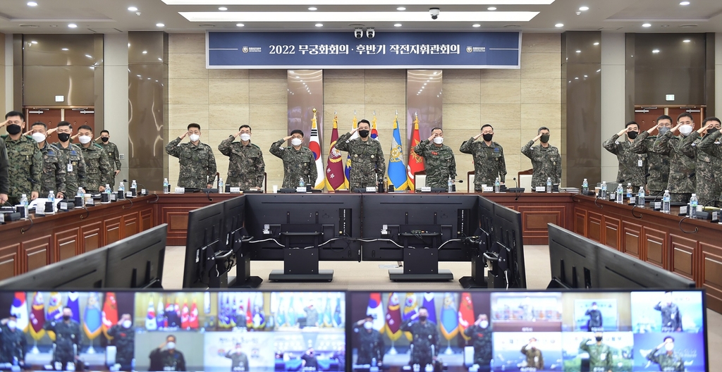 Joint Chiefs of Staff (JCS) Chairman Gen. Kim Seung-kyum (C) and other top commanders salute as they kick off a top-brass meeting on military readiness at the JCS headquarters in Seoul on Dec. 21, 2022, in this photo released by the JCS. (PHOTO NOT FOR SALE) (Yonhap)