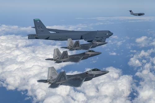 A U.S. B-52H bomber, F-22 stealth fighters and C-17 aircraft are seen flying for combined air drills with South Korean forces near the Korean Peninsula on Dec. 20, 2022, in this photo released by the Korean Air Force. (PHOTO NOT FOR SALE) (Yonhap) 