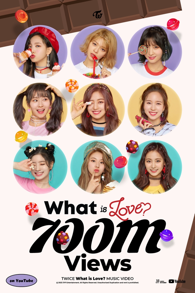 This photo provided by JYP Entertainment on Feb. 15, 2023, shows a poster celebrating TWICE's "What is Love?" music video surpassing 700 million YouTube views. (PHOTO NOT FOR SALE) (Yonhap)