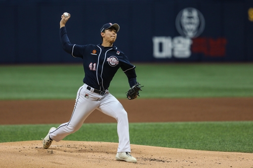 IU throws the opening pitch for the Doosan Bears