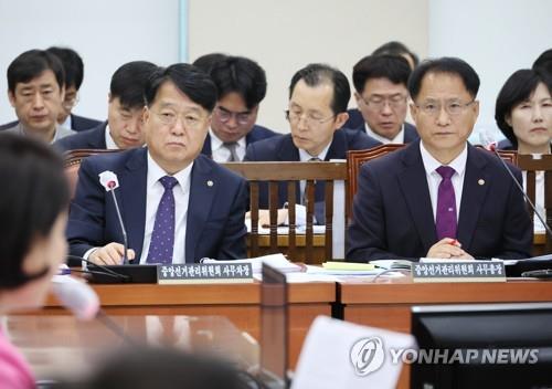 Secretary General Park Chan-jin (R) of the National Election Commission and Park's deputy, Song Bong-sup, attend a hearing held at the National Assembly in Seoul on May 16, 2023. (Yonhap)