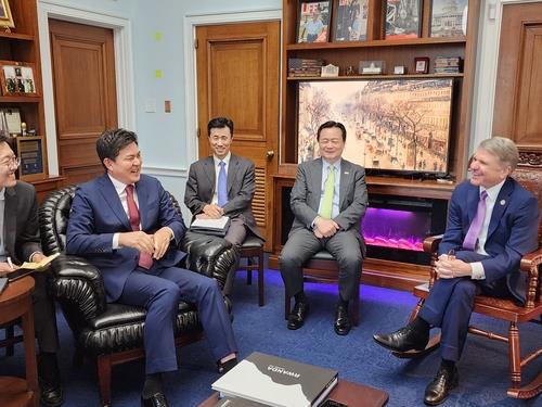 Rep. Kim Tae-ho (second from left), chairman of the parliamentary foreign affairs committee, smiles during a meeting with Congressman Michael McCaul in Washington on June 22, 2023 (local time). (PHOTO NOT FOR SALE) (Yonhap)