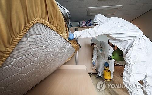 In this file photo, workers disinfect a university dorm room in the southeastern city of Daegu on Oct. 19, 2023, following a report of bedbugs. (Yonhap)