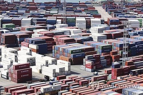 Shipping containers are stacked at a pier in South Korea's largest port city of Busan, in this Oct. 11, 2023, file photo. (Yonhap)