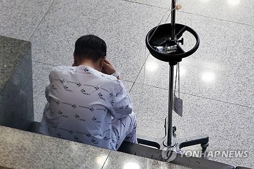 A patient sits down in the lobby of a general hospital in Seoul on April 14, 2024. (Yonhap)