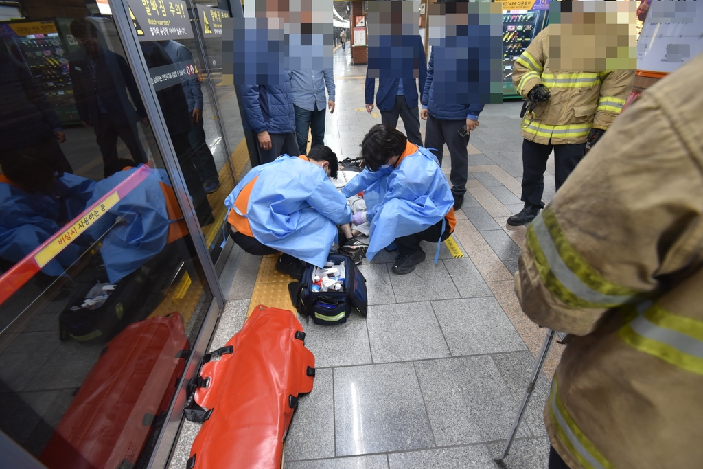 시민들의 도움으로 발을 뺀 환자에게 응급조치 중인 구급대원들.