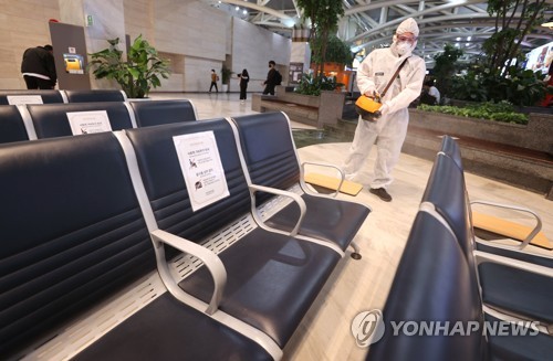 Un trabajador sanitario, vestido con traje protector, desinfecta una terminal de autobuses expresos en Seúl, el 17 de septiembre de 2021, antes de la festividad del Chuseok.