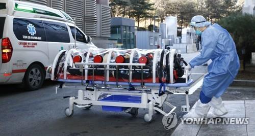 La foto sin fechar, proporcionada por el Hospital Ilsan, operado por el Servicio Nacional del Seguro de Enfermedad (NHIS, según sus siglas en inglés), muestra un trabajador del hospital trasladando a un paciente de COVID-19 en el distrito de Ilsan, en la ciudad de Goyang, provincia de Gyeonggi, al noroeste de Seúl. (Prohibida su reventa y archivo)