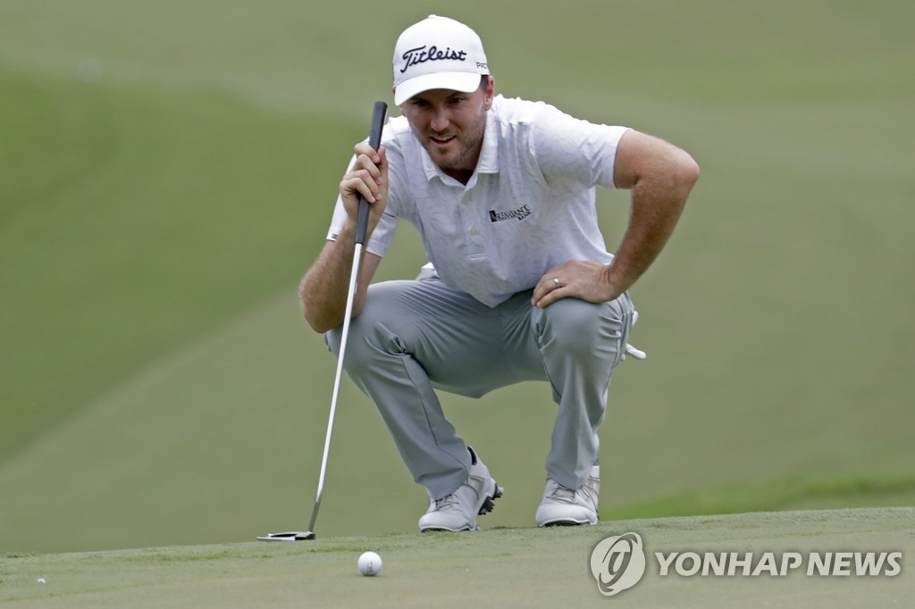 Henry checking the green on the 17th hole in round 3