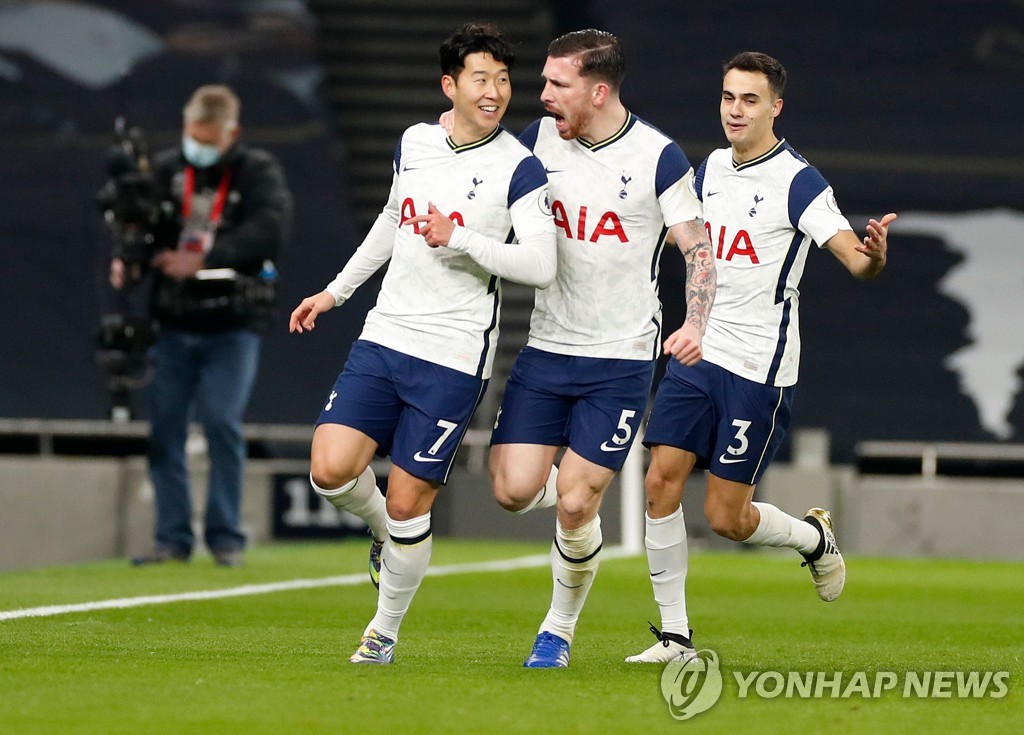 In this AFP photo, Son Heung-min of Tottenham Hotspur (L) is congratulated by teammates Pierre-Emile Hojbjerg (C) and Sergio Reguilon after scoring a goal against Arsenal in a Premier League match at Tottenham Hotspur Stadium in London on Dec. 6, 2020. (Yonhap)