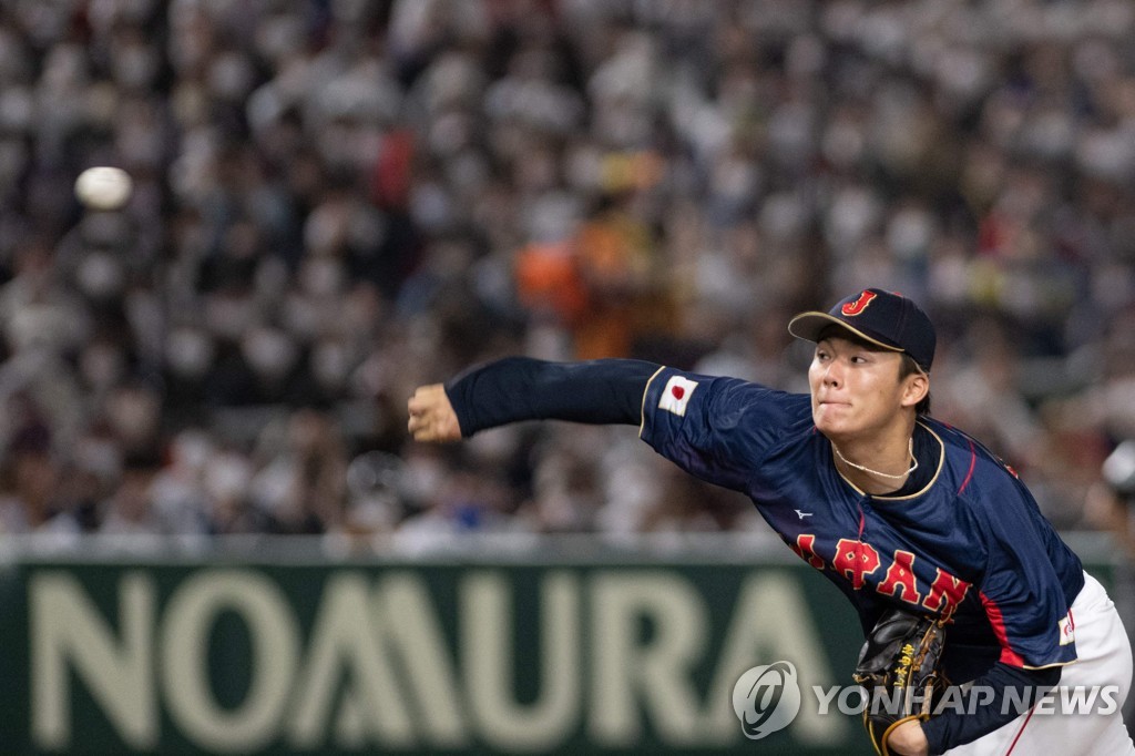 In this AFP photo, Yoshinobu Yamamoto of Japan pitches against Australia during a Pool B game at the World Baseball Classic at Tokyo Dome in Tokyo on March 12, 2023. (Yonhap)