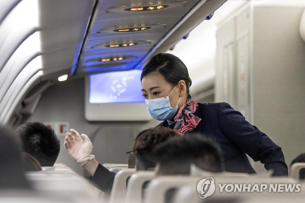 한 중국 항공사의 객실 승무원이 마스크와 일회용 장갑을 착용한 채 근무 중인 모습.[EPA=연합뉴스 자료사진]