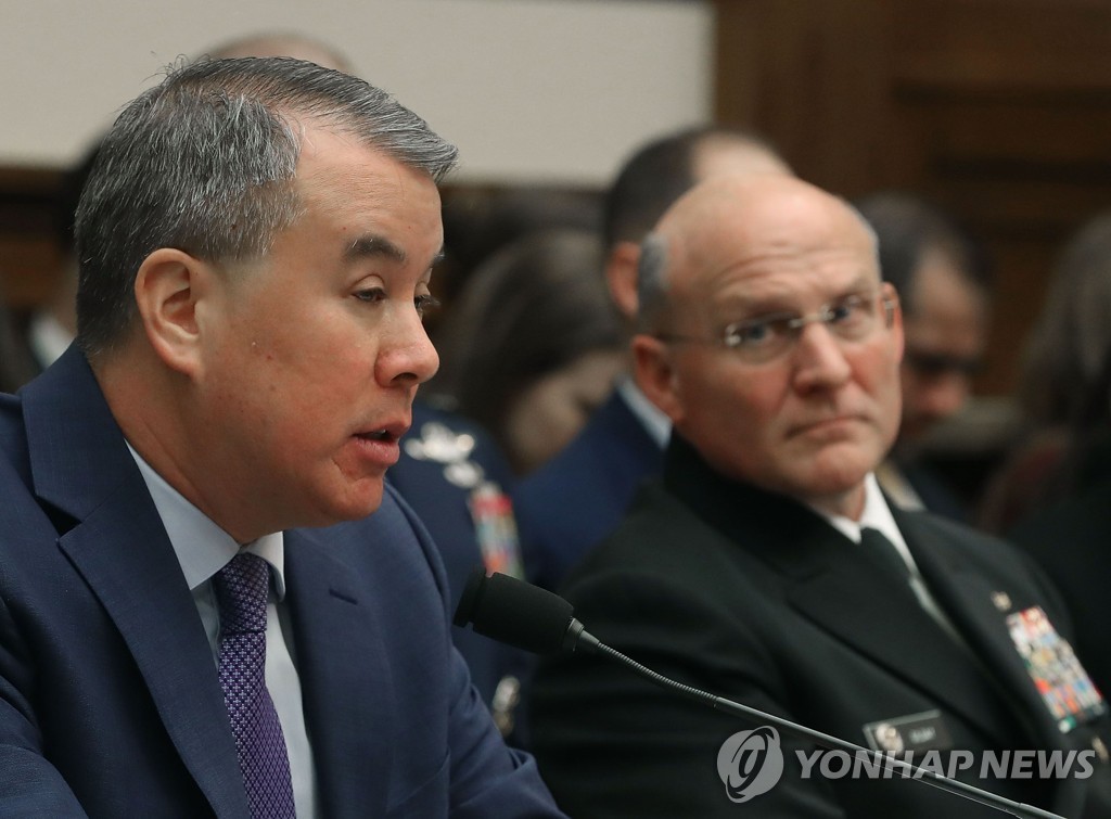 This AFP file photo shows U.S. Defense Undersecretary for Policy John Rood (L). (Yonhap)