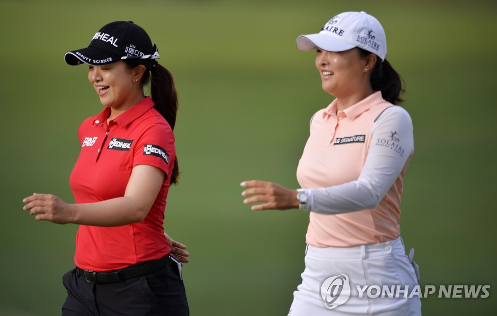 In this Getty Images photo, Kim Sei-young (L) and Ko Jin-young of South Korea walk from the first tee during the second round of the KPMG Women's PGA Championship at Atlanta Athletic Club in Johns Creek, Georgia, on June 27, 2021. (Yonhap)
