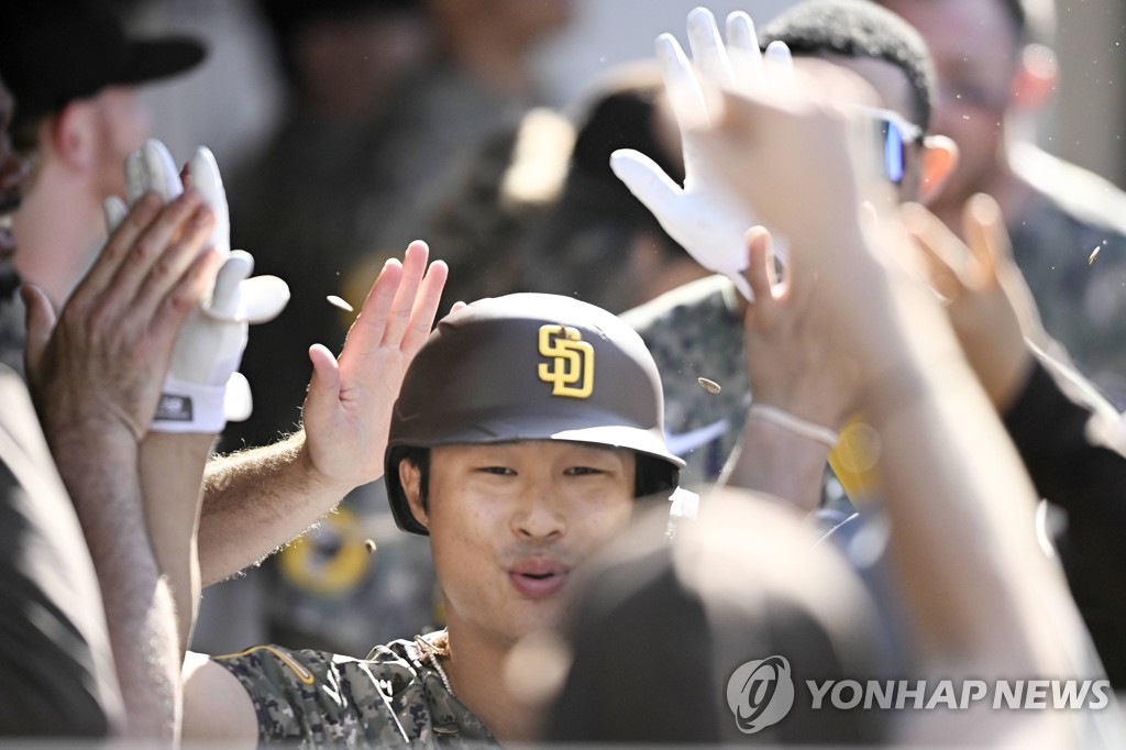 In this Getty Images photo, Kim Ha-seong of the San Diego Padres is congratulated by teammates in the dugout after hitting a home run against the Chicago White Sox during the bottom of the seventh inning of a Major League Baseball regular season game at Petco Park in San Diego on Oct. 2, 2022. (Yonhap)
