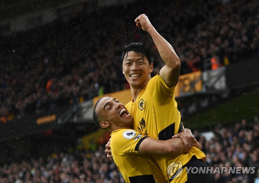 In this Reuters photo, Hwang Hee-chan of Wolverhampton Wanderers (R) is congratulated by teammate Marcal after scoring a goal against Newcastle United during the clubs' Premier League match at Molineux Stadium in Wolverhampton, England, on Oct. 2, 2021. (Yonhap)