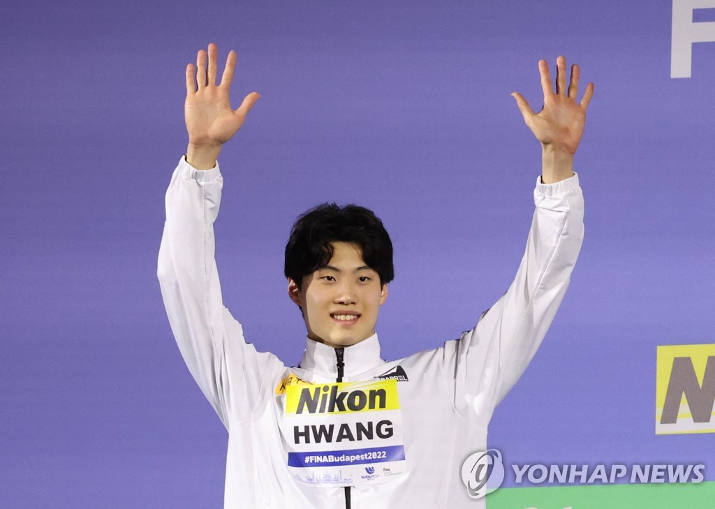 In this Reuters photo, Hwang Sun-woo of South Korea celebrates on the podium after winning silver in the men's 200m freestyle at the FINA World Championships at Duna Arena in Budapest on June 20, 2022. (Yonhap)
