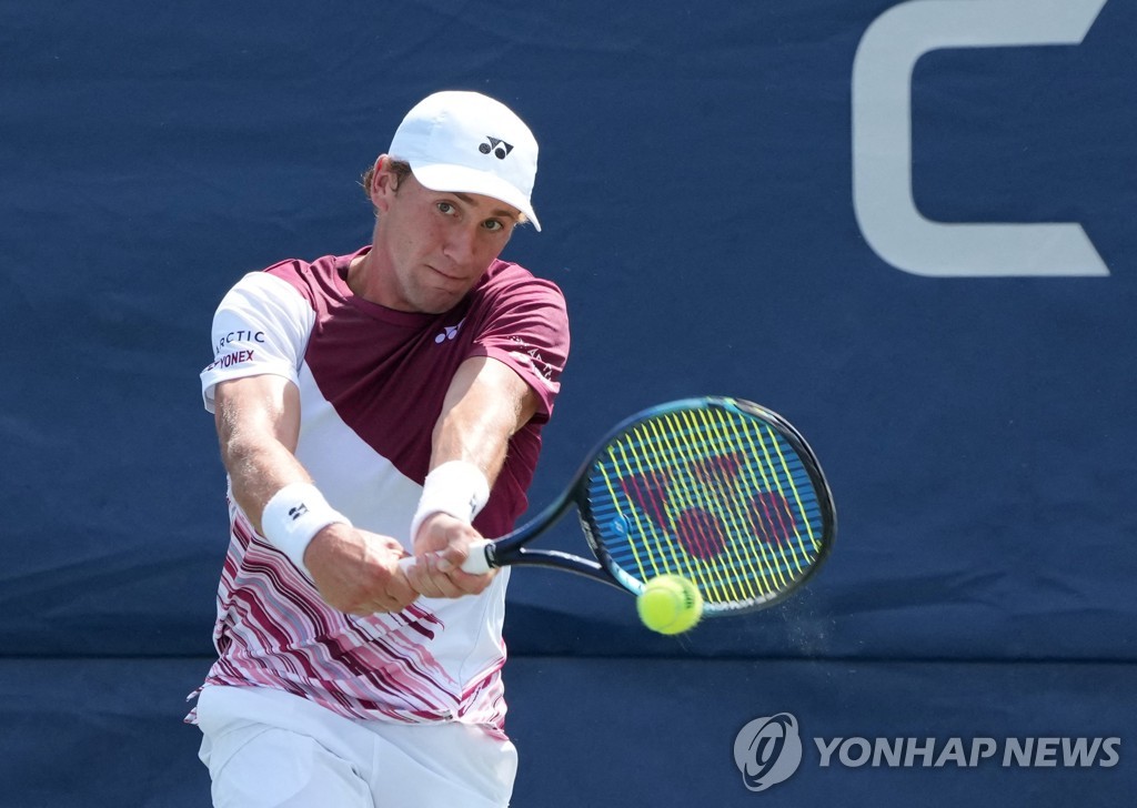 In this USA Today Sports photo via Reuters, Casper Rudd of Norway hits a shot to Kyle Edmund of Britain during their men's singles first round match at the U.S. Open at the USTA Billie Jean King National Tennis Center in New York on Aug. 30, 2022. (Yonhap)