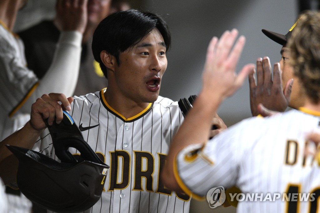 In this USA Today Sports photo via Reuters, Kim Ha-seong of the San Diego Padres celebrates with teammates in the dugout after scoring a run against the San Francisco Giants during the bottom of the sixth inning of a Major League Baseball regular season game at Petco Park in San Diego on Oct. 4, 2022. (Yonhap)