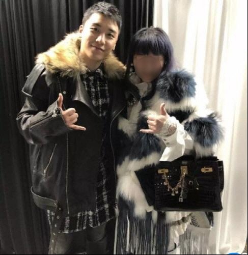 This photo is a capture from the Taiwanese Next Magazine showing Seungri (L) and a face-blurred Taiwanese businesswoman known to have invested in the nightclub Burning Sun. (Yonhap) 