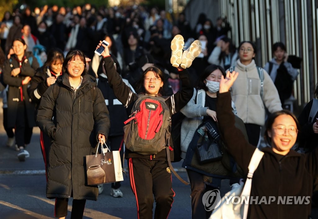 This file photo, taken Nov. 14, 2019 in Gwangju, some 320 kilometers south of Seoul, shows students smiling after they finished the college entrance exam. (Yonhap)
