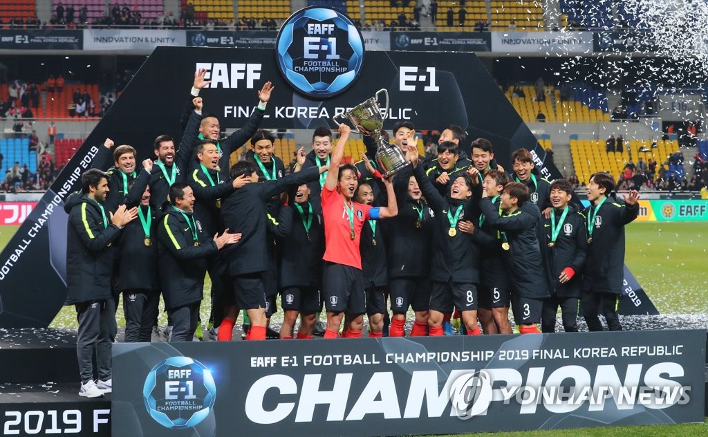 In this file photo from Dec. 18, 2019, members of the South Korean men's national football team celebrate their title at the East Asian Football Federation (EAFF) E-1 Football Championship at Busan Asiad Main Stadium in Busan, 450 kilometers southeast of Seoul. (Yonhap)