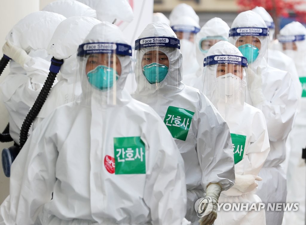 Nurses in full protective suits line up to enter a treatment ward for novel coronavirus patients at Dongsan Hospital in Daegu, 300 kilometers southeast of Seoul, on April 7, 2020. (Yonhap)