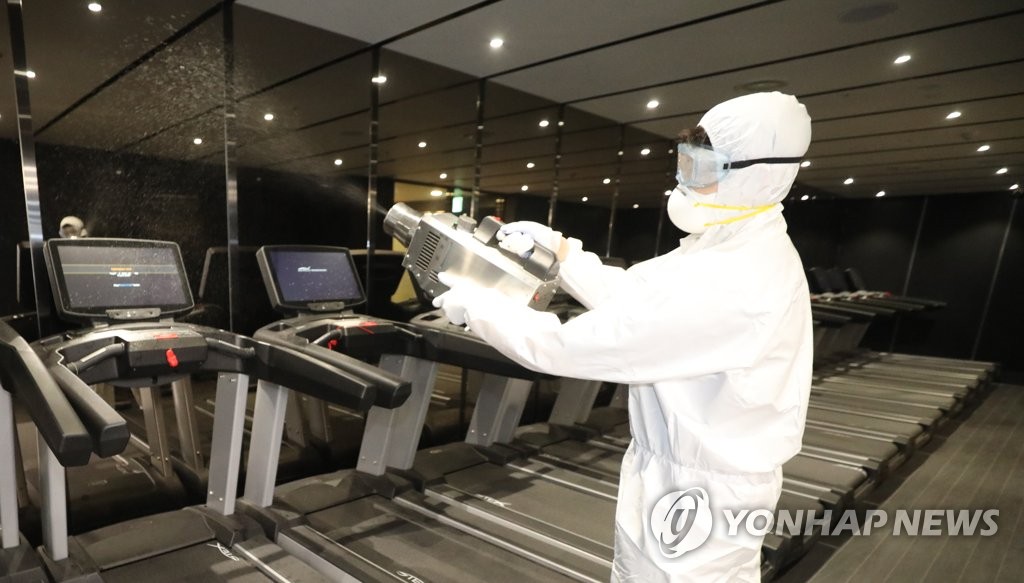 A quarantine worker carries out a disinfection operation at a gym in Seoul's popular multicultural neighborhood of Itaewon on May 11, 2020. (Yonhap)