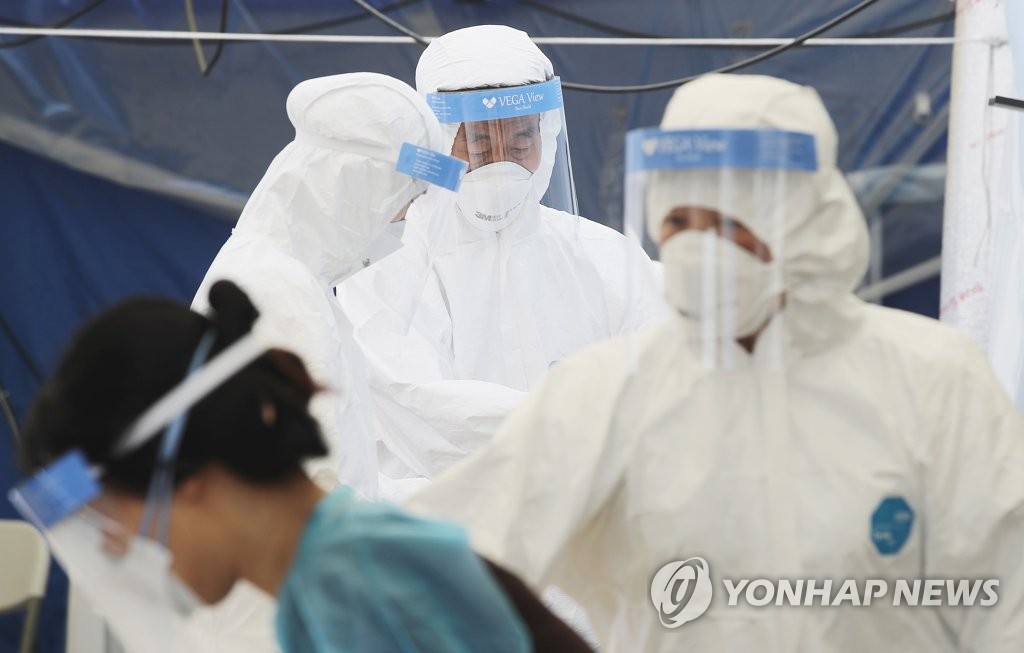 Medical staffs work at a makeshift COVID-19 test clinic in Seoul, on May 27, 2020. (Yonhap)