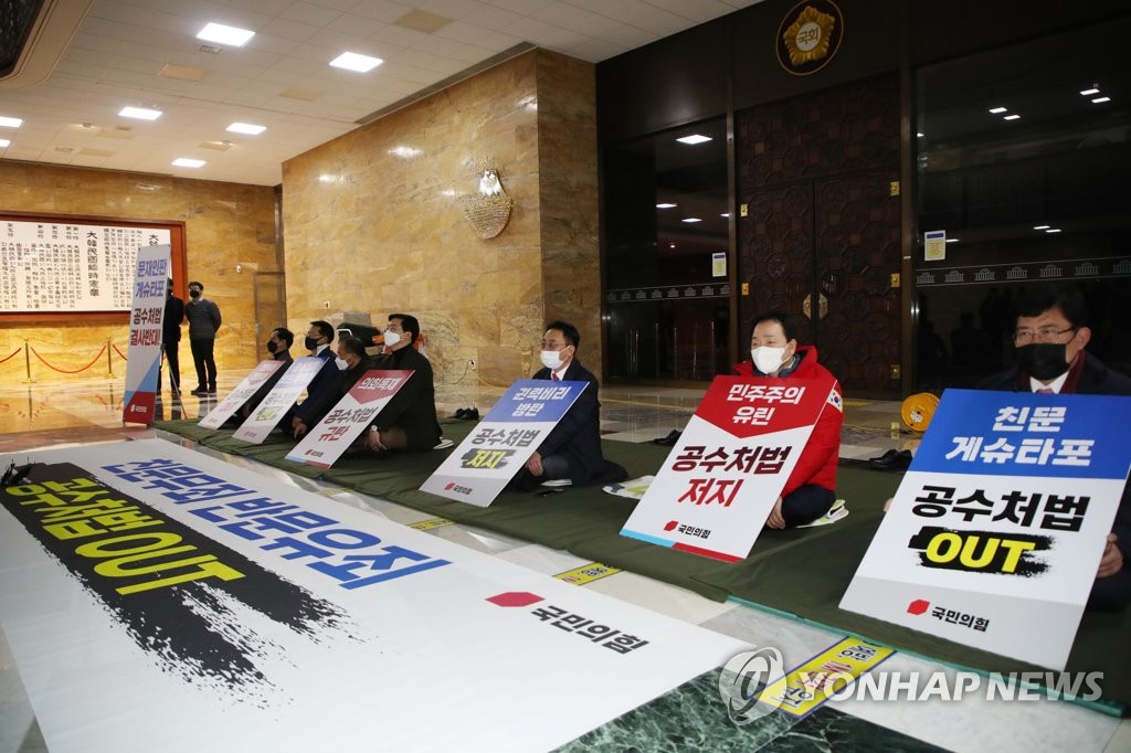 Members of the main opposition People Power Party (PPP) stage a sit-in protest at the National Assembly in Seoul, on Dec. 7, 2020, holding pickets opposing the ruling Democratic Party (DP)'s unilateral passage of a bill through a parliamentary committee on a new agency to investigate high-profile corruption. (Yonhap)
