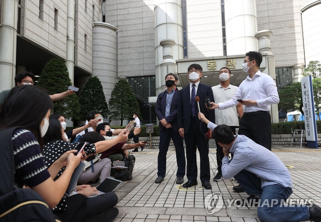 Representatives of the family of a victim of World War II forced labor, surnamed Jeong, speak to reporters at the Seoul Central District Court in Seoul on Sept. 8, 2021, after the court dismissed a damages suit filed by them against Japan's Nippon Steel Corp. (Yonhap)