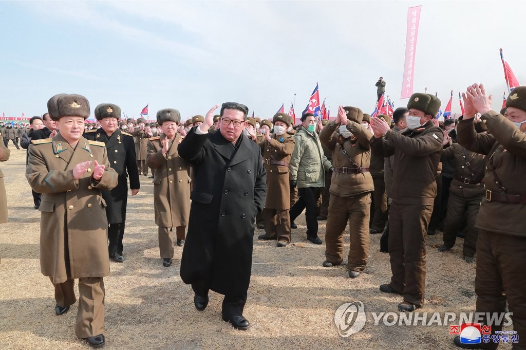 North Korean leader Kim Jong-un, clad in a black coat, waves to a crowd of officials and workers at the groundbreaking ceremony of a greenhouse farm project in the country's eastern province of South Hamgyong, on Feb. 18, 2022, in this photo published a day after by the North's Korean Central News Agency. [For Use Only in the Republic of Korea. No Redistribution] (Yonhap)