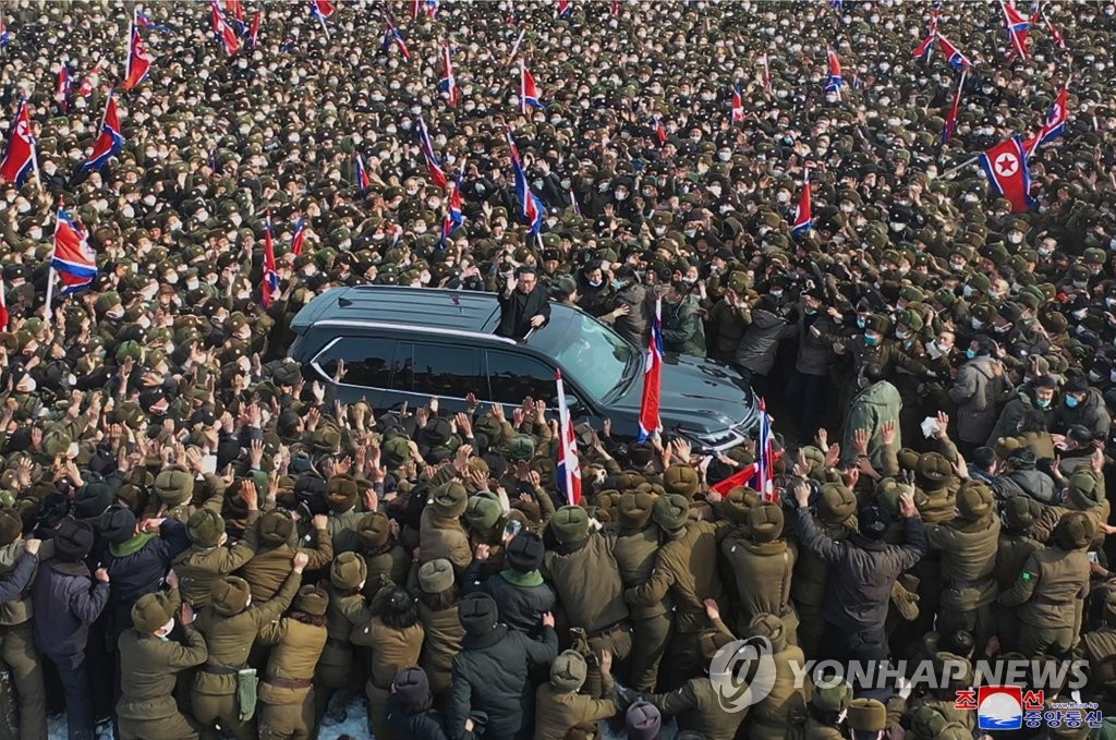 North Korean leader Kim Jong-un stands through a sunroof of an SUV to wave to the crowd during a groundbreaking ceremony of a greenhouse farm construction in the Hamju county, South Hamgyong Province, on Feb. 18, 2022, in this photo provided a day later by the North's Korean Central News Agency. [For Use Only in the Republic of Korea. No Redistribution] (Yonhap) 