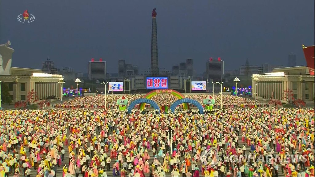 This image from North Korea's Korean Central Television shows students dancing at Kim Il-sung Square in Pyongyang on April 15, 2022, during an event to celebrate the 110th birth anniversary of late national founder Kim Il-sung. (For Use Only in the Republic of Korea. No Redistribution) (Yonhap)