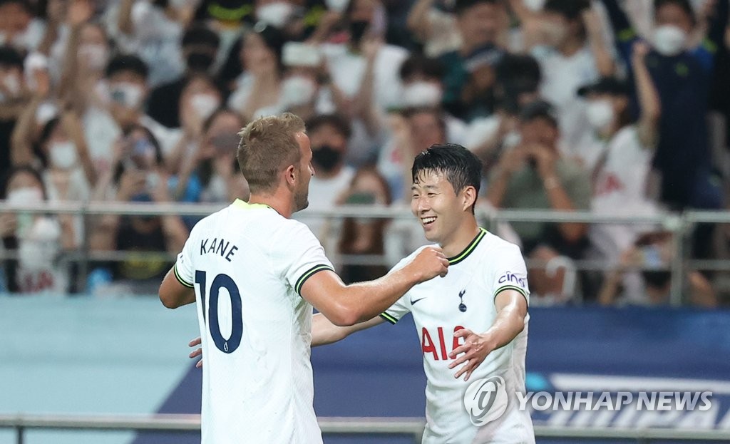 Harry Kane of Tottenham Hotspur (L) is congratulated by teammate Son Heung-min after scoring a goal against Team L League during the teams' exhibition match at Seoul World Cup Stadium in Seoul on July 13, 2022. (Yonhap)