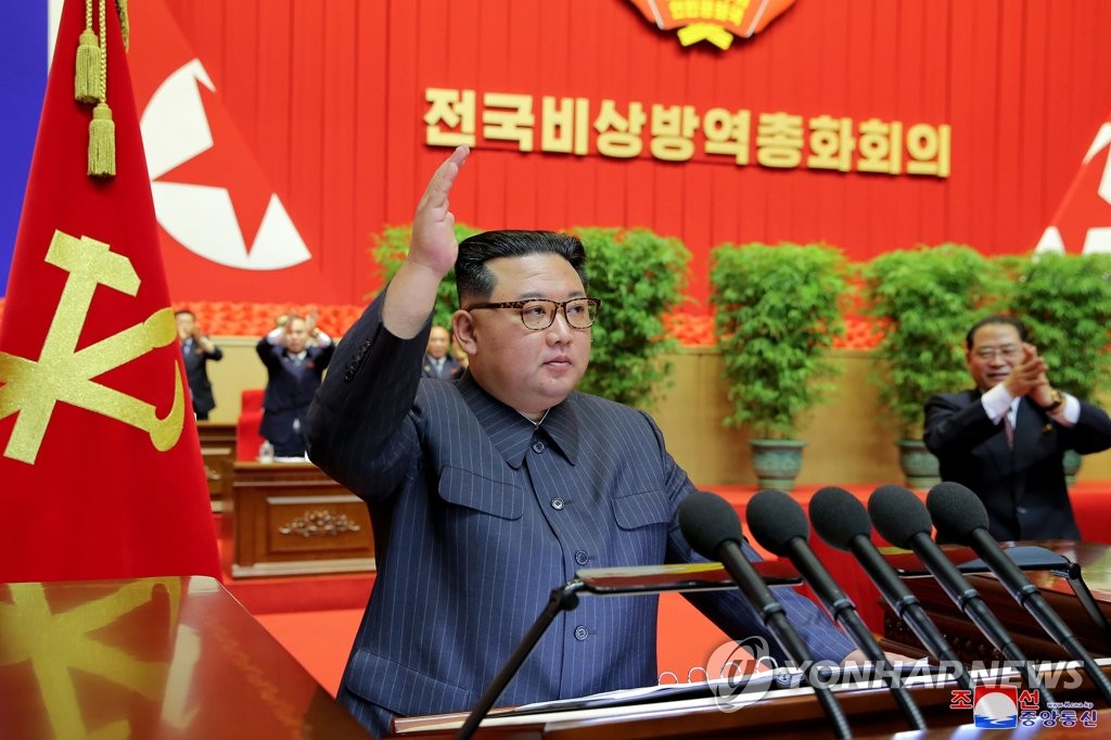 This photo, released by the North's official Korean Central News Agency on Aug. 11, 2022, shows North Korean leader Kim Jong-un greeting participants at a national meeting to declare victory in the country's fight against COVID-19 in Pyongyang the previous day. (For Use Only in the Republic of Korea. No Redistribution) (Yonhap)