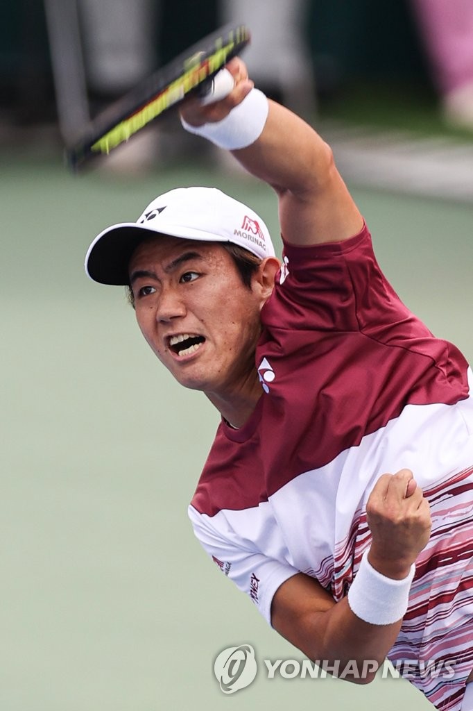 Yoshihito Nishioka of Japan serves the ball to Denis Shapovalov of Canada during the men's singles final at the ATP Eugene Korea Open at Olympic Park Tennis Center in Seoul on Oct. 2, 2022. (Yonhap)