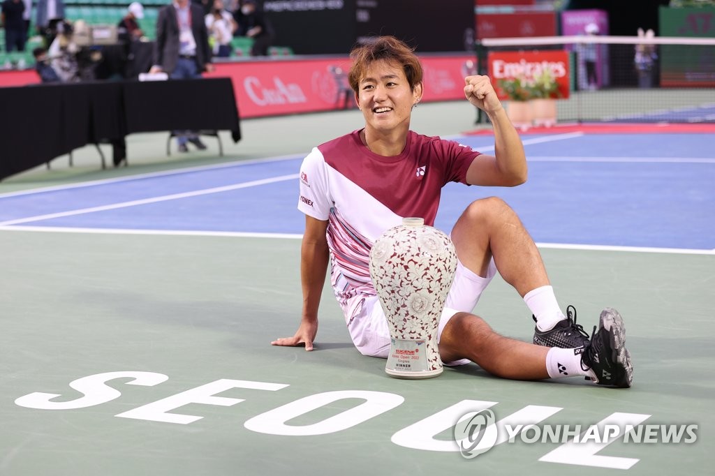 Yoshihito Nishioka of Japan celebrates his victory over Denis Shapovalov of Canada in the men's singles final at the ATP Eugene Korea Open at Olympic Park Tennis Center in Seoul on Oct. 2, 2022. (Yonhap)