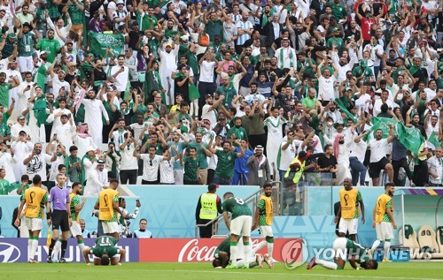 Supporters for Saudi Arabia celebrate their team's goal against Argentina during the countries' Group C match at the FIFA World Cup at Lusail Stadium in Lusail, north of Doha, on Nov. 22, 2022. (Yonhap)