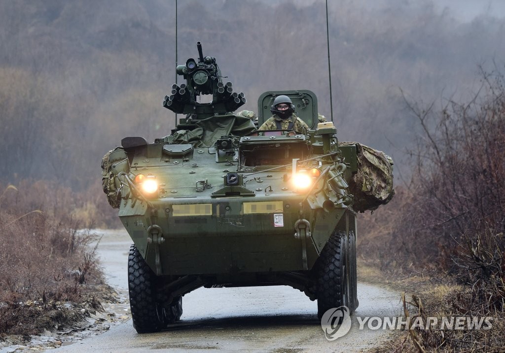 An eight-wheeled U.S. Stryker combat vehicle rolls down a hill during a joint exercise with the South Korean Army's TIGER Demonstration Brigade at the Mugeon-ri training ground in Paju, Gyeonggi Province, on Jan. 13, 2022. (Pool photo) (Yonhap)