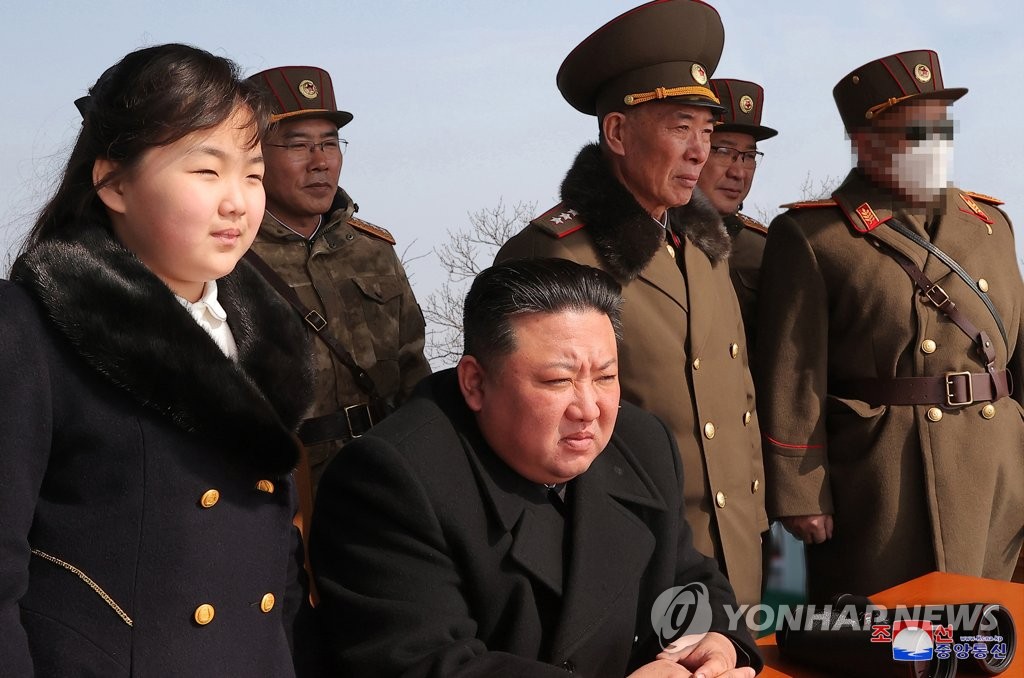 This photo, carried by North Korea's official Korean Central News Agency on March 20, 2023, shows the North's leader Kim Jong-un (C) and his daughter Ju-ae overseeing the country's two-day drills simulating tactical nuclear attack over the weekend. (For Use Only in the Republic of Korea. No Redistribution) (Yonhap)