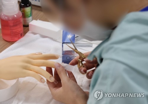 A North Korean defector receives job training in nail art at Hanawon, a resettlement education center for North Korean defectors, in Anseong, southeast of Seoul, on July 10, 2023. (Pool photo) (Yonhap)