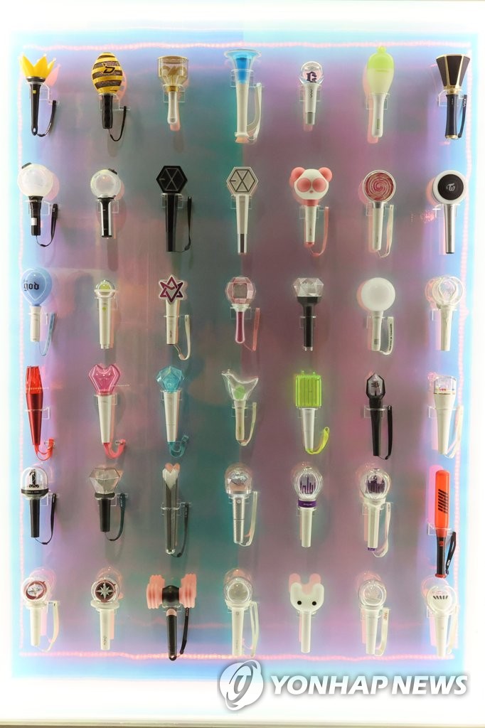 Various light sticks used for K-pop concerts are on display at an exhibition, titled "The Pop Culture We Loved, and Rise of the Korean Wave," at the National Museum of Korean Contemporary History in Seoul on July 20, 2023. (Yonhap)