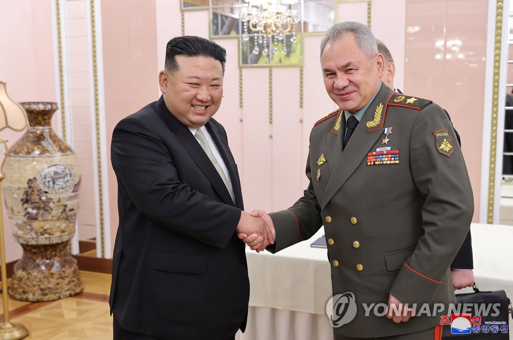 North Korean leader Kim Jong-un (L) shakes hands with Russian Defense Minister Sergei Shoigu during their meeting at the headquarters of the Workers' Party of Korea's Central Committee in Pyongyang on July 26, 2023, in this photo released by the North's official Korean Central News Agency. A Russian military delegation, led by Shoigu, visited the North to celebrate the 70th anniversary the next day of the armistice that halted the 1950-53 Korean War. (For Use Only in the Republic of Korea. No Redistribution)