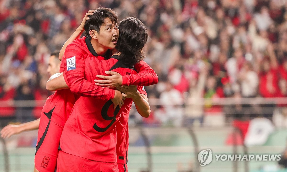 Lee Kang-in of South Korea (L) is congratulated by teammate Cho Gue-sung after scoring against Tunisia during the teams' friendly football match at Seoul World Cup Stadium in Seoul on Oct. 13, 2023. (Yonhap)