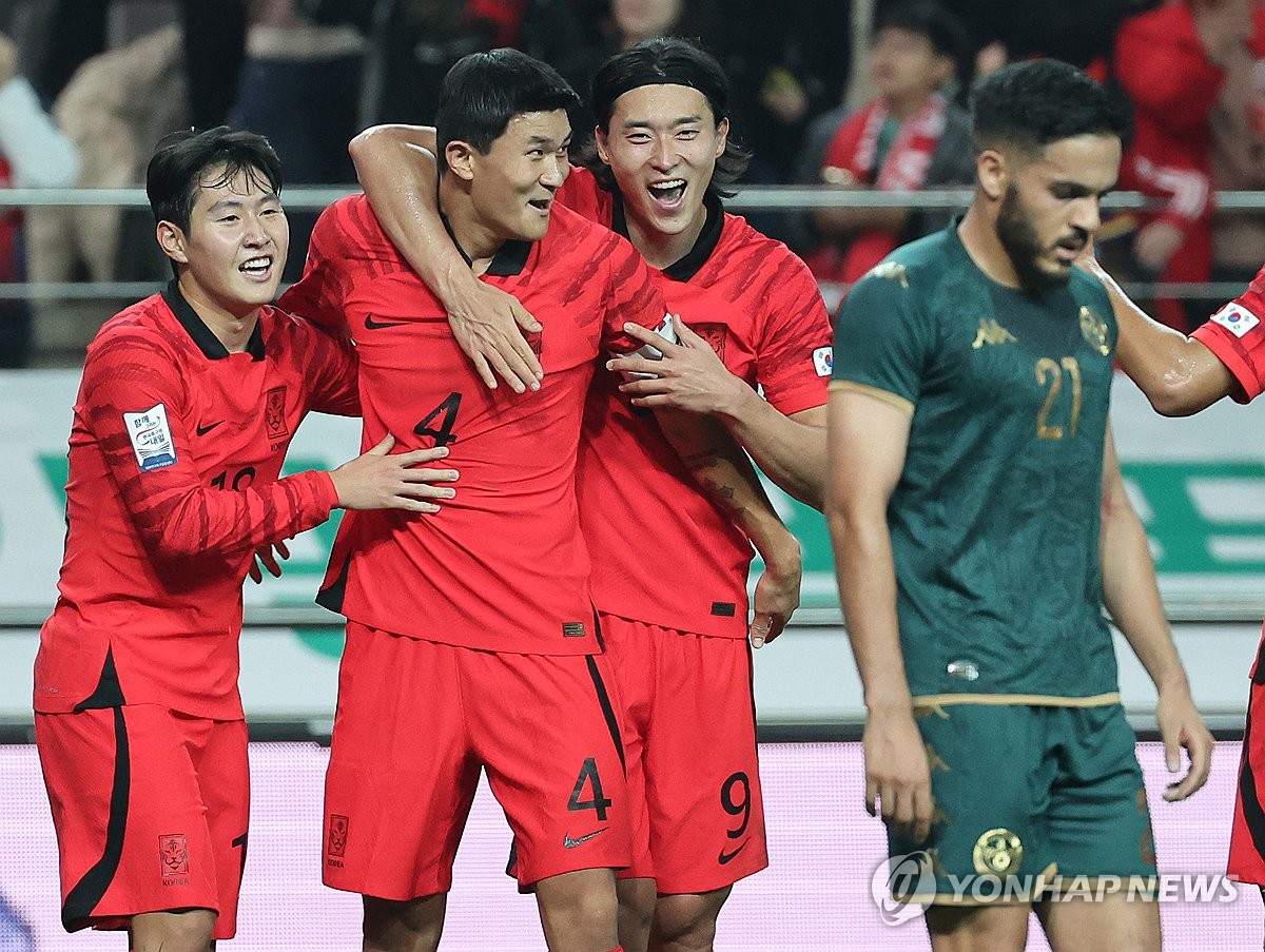 South Korean players Lee Kang-in, Kim Min-jae and Cho Gue-sung (L to R) celebrate after an own goal by Tunisia during the teams' friendly football match at Seoul World Cup Stadium in Seoul on Oct. 13, 2023. (Yonhap)