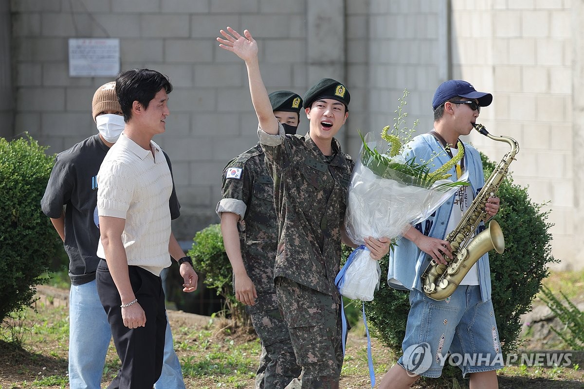 BTS member Jin waves after being discharged from the 5th Army Infantry Division in Yeoncheon, 61 kilometers north of Seoul, on June 12, 2024. (Yonhap)