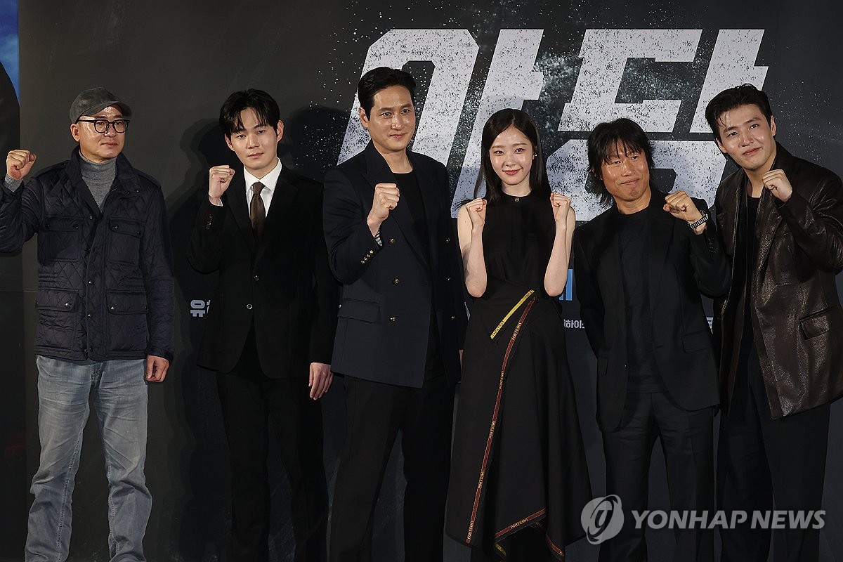 Cast members and director Hwang Byeong-guk (L) of "Yadang: The Snitch" pose for photos at a press event in Seoul on March 13, 2025. (Yonhap)